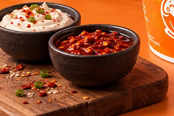 Mayo and chilli dipping sauces served with Ama Momo steamed momo