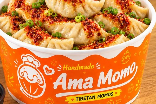 Vegetarian momo topped with chilli oil