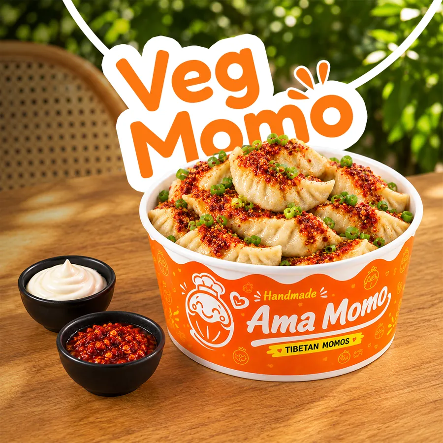 Steamed vegetarian momo with chilli oil and spring onion in an Ama Momo bowl